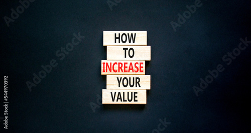 Increase your value symbol. Concept words How to increase your value on wooden blocks. Beautiful black table black background. Business how to increase your value concept. Copy space.