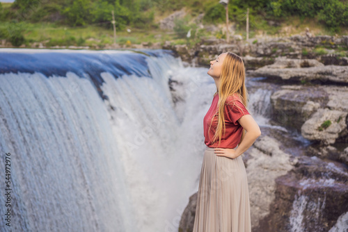 Woman tourist on background of Picturesque Niagara Falls on the river Cievna. Montenegro, near Podgorica. Travel around Montenegro concept
