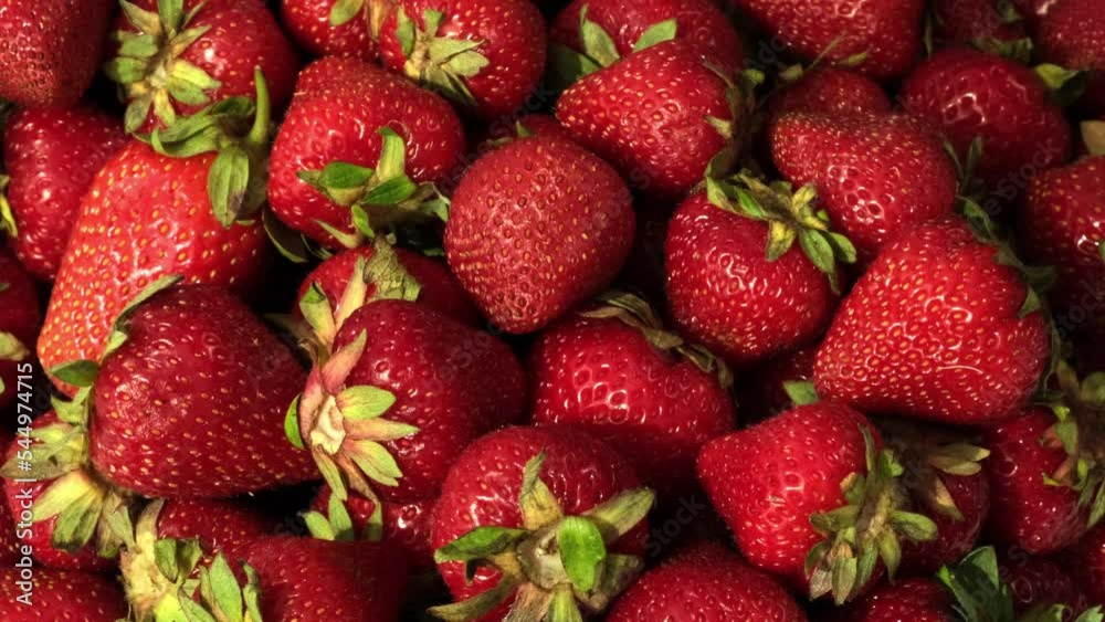 Strawberry. Harvest of ripe red strawberries rotating. Sweet and tasty red fresh berries. Vegetarian Food, Eating Concept. Strawberry fruit background close-up Strawberry. Harvest of ripe red strawberries rotating. Sweet and tasty red fresh berries. Vegetarian Food, Eating Concept. Strawberry fruit background close-up