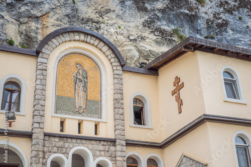 Monastery of Ostrog, Serbian Orthodox Church situated against a vertical background, high up in the large rock of Ostroska Greda, Montenegro. Dedicated to Saint Basil of Ostrog photo