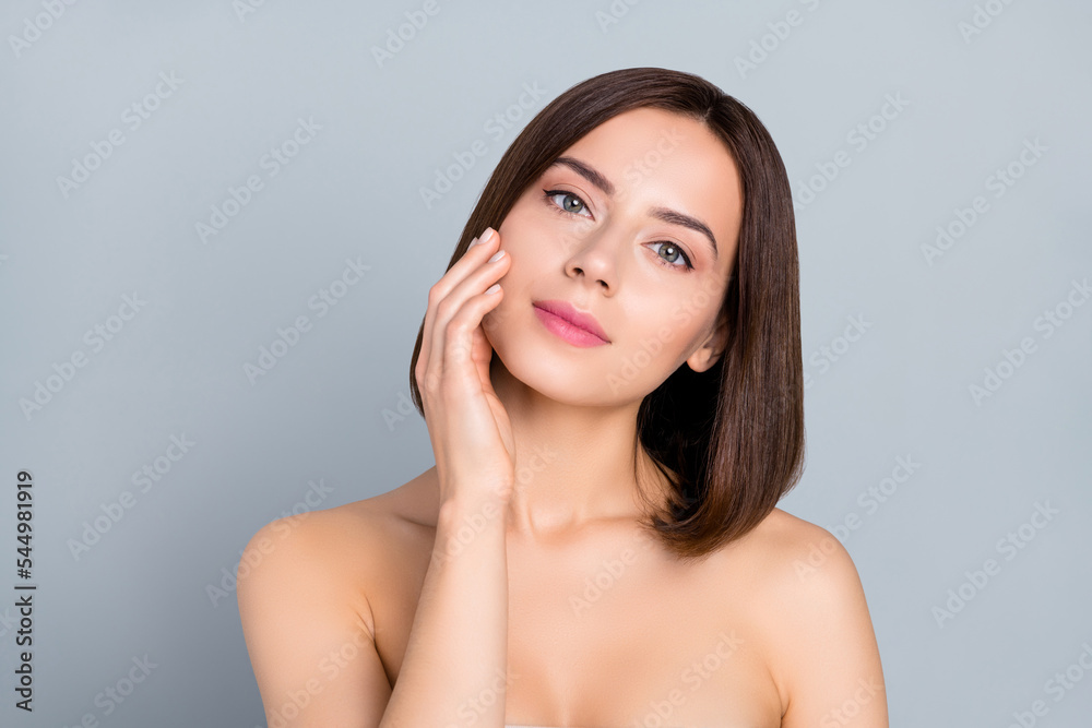 Photo of lady touch her pure ideal complexion skin after hygiene plastic collagen surgery isolated over grey color background Photo of lady touch her pure ideal complexion skin after hygiene plastic collagen surgery isolated over grey color background