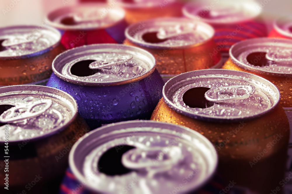 Beer cans. Aluminum cans. Close-up of many multicolored empty cans with condensation drops. Recycling and reuse. Selective focus. Beer cans. Aluminum cans. Close-up of many multicolored empty cans with condensation drops. Recycling and reuse. Selective focus.