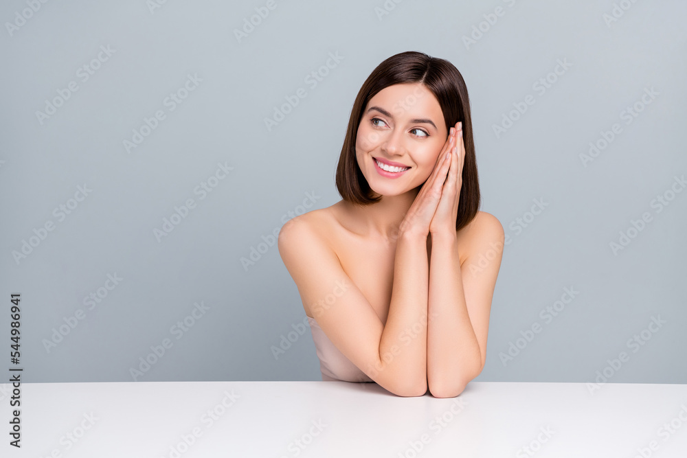 Fototapeta premium Photo of joyful lady sit table look empty space cleansing collagen detox advert isolated over grey color background