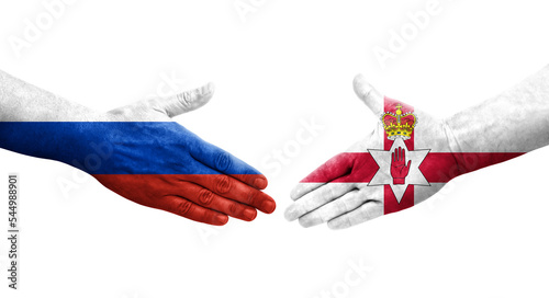 Handshake between Northern Ireland and Russia flags painted on hands, isolated transparent image. photo