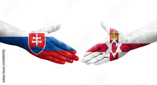 Handshake between Northern Ireland and Slovakia flags painted on hands, isolated transparent image. photo