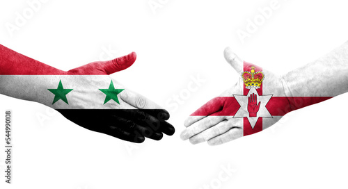 Handshake between Northern Ireland and Syria flags painted on hands, isolated transparent image. photo