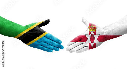 Handshake between Northern Ireland and Tanzania flags painted on hands, isolated transparent image. photo