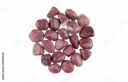 Closeup of Thulite tumbled stones isolated on white background. Thulite is a type of Zoisite stone. photo