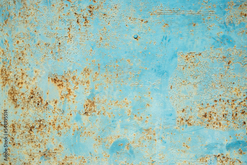 Old weathered rusty tin metal sheet surface closeup as grunge blue background