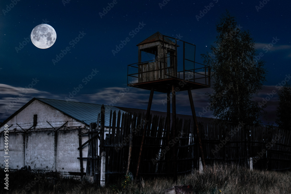 Old observation tower in old Soviet Russian prison complex at moonlight night Old observation tower in old Soviet Russian prison complex at moonlight night