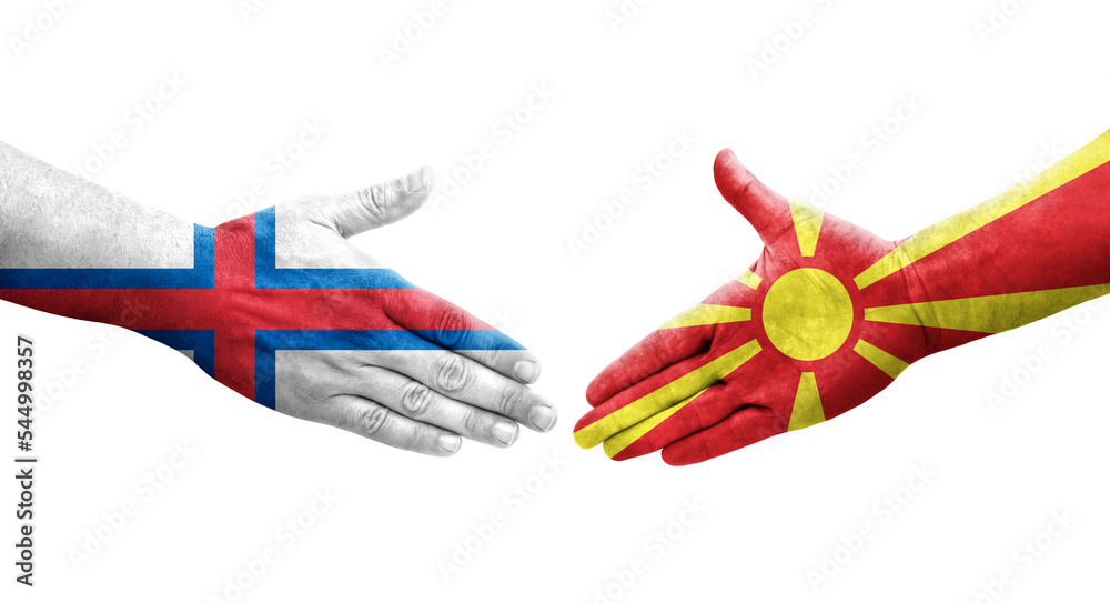 Handshake between North Macedonia and Faroe Islands flags painted on hands, isolated transparent image. Handshake between North Macedonia and Faroe Islands flags painted on hands, isolated transparent image.
