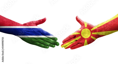 Handshake between North Macedonia and Gambia flags painted on hands, isolated transparent image.