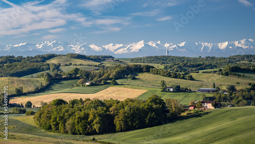 Countryside landscape in the Gers department in France with the Pyrenees mountains in the background photo