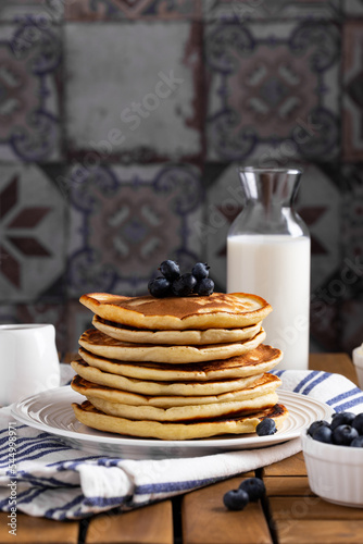 Pancakes with blueberry on a wooden table