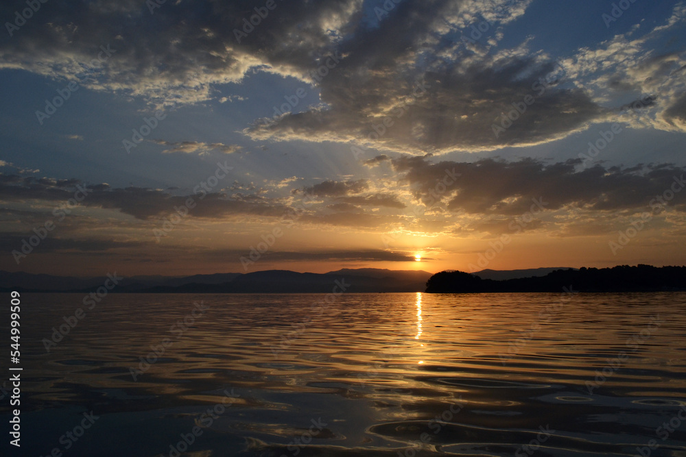 View of Albania and Lazareto island from a sailboat during sunrise.
