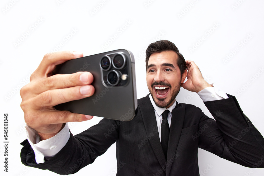 Man businessman holding the phone and smiling happily with teeth of surprise. Trading and winning at casinos online via phone. Close-up wide angle photo white isolated background Man businessman holding the phone and smiling happily with teeth of surprise. Trading and winning at casinos online via phone. Close-up wide angle photo white isolated background