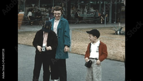 Focusing the Shot 1955 - A boy focuses his camera on the camerman while his mother and brother observe in 1955. 