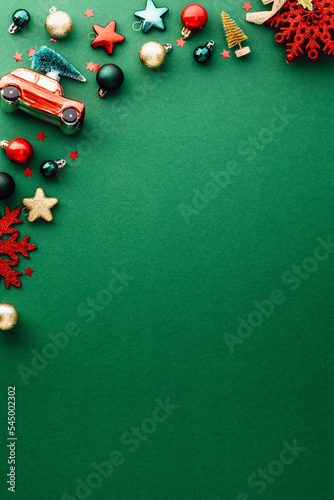 Merry Christmas and Happy New Year poster template. Christmas green vertical background with baubles, decorations, stars. Flat lay, top view.