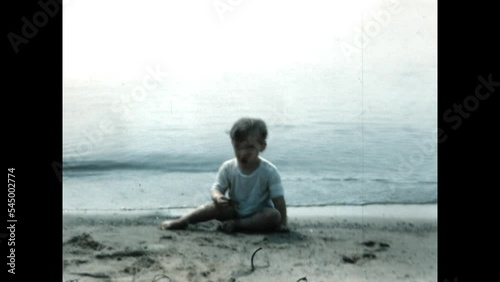 Crawling on the Beach 1951 - A toddler crawls at Wilmette Beach, Illinois on Lake Michigan in 1951. photo