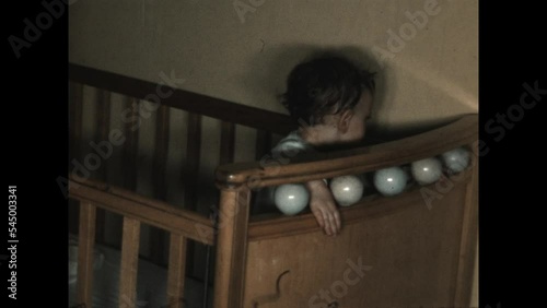 Bouncing in the Crib 1951 - A toddler bounces in a crib in 1951.  photo