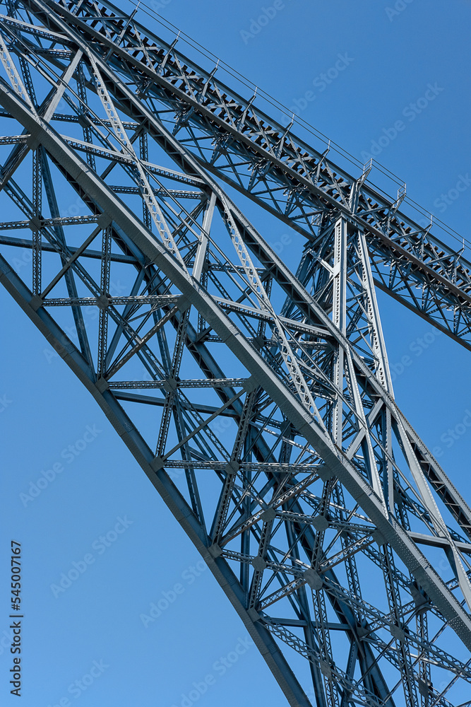 Close-up detail of the iron structure of Ponte de Dom Luis I, iconic double-deck metal arch bridge spanning over Douro River and connecting Ribeira and Vila Nova de Gaia neighborhoods, Porto, Portugal