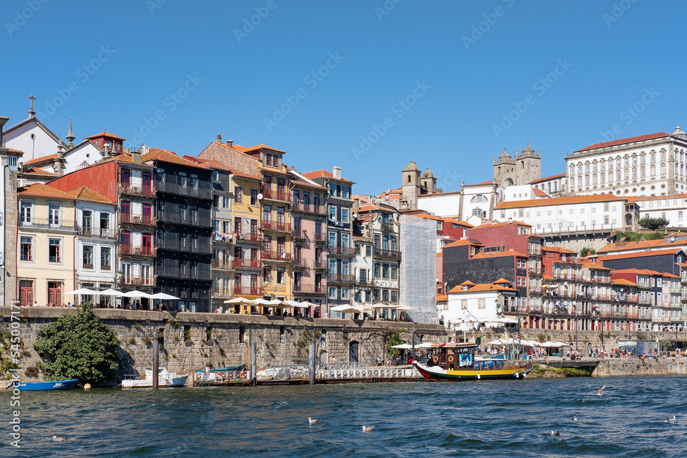 Views of the famous Ribeira neighborhood, one of the most authentic and picturesque part of the town, an UNESCO World Heritage Site, as seen from the River Douro in Porto, Portugal