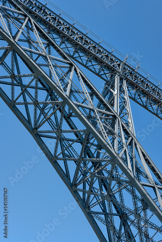 Close-up detail of the iron structure of Ponte de Dom Luis I, iconic double-deck metal arch bridge spanning over Douro River and connecting Ribeira and Vila Nova de Gaia neighborhoods, Porto, Portugal