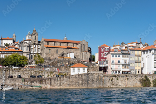 View of the city toward the northern bank from Douro River, eclectic urban display of various architectural styles with major cultural and historical significance in Porto, Portugal