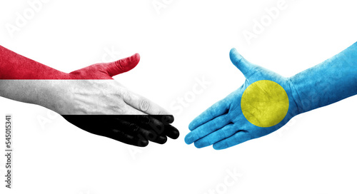 Handshake between Palau and Yemen flags painted on hands, isolated transparent image.