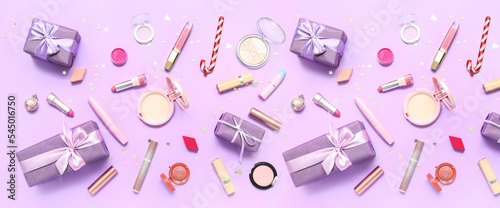 Makeup cosmetics with Christmas gifts on lilac background
