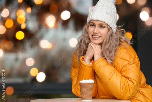 Beautiful young woman drink...