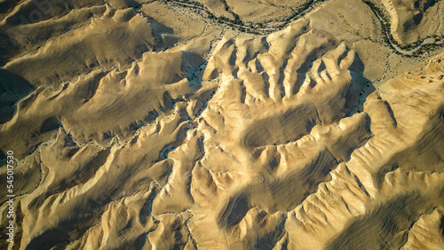 Gorgeous aerial drone top bird's eye view of incredible golden  desert mountains of tzin river. desert in Israel
