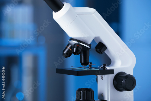 Modern medical microscope against blurred background, closeup
