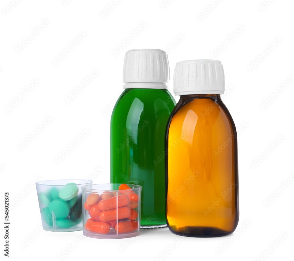 Bottles of syrups with pills on white background. Cough and cold medicine