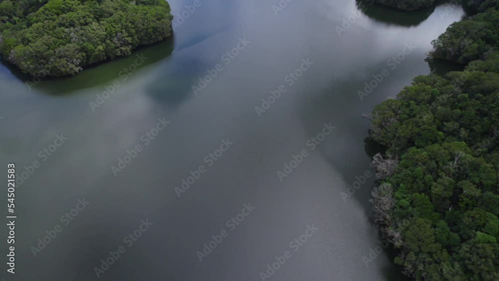 Drone Flight Over Copperlode Dam With Cloudy Sky Reflected On Water In Cairns, North Queensland, Australia Drone Flight Over Copperlode Dam With Cloudy Sky Reflected On Water In Cairns, North Queensland, Australia