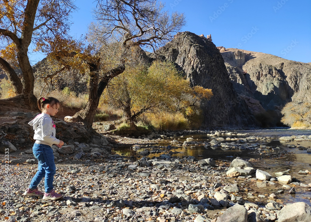 Little girl playing on the shores of Charyn river in Kazakhstan.
