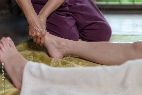 Professional masseur doing therapeutic massage. Woman enjoying massage  Young woman getting relaxing body massage beauty spa center body care  skin care  wellness  wellness  beauty treatment concept