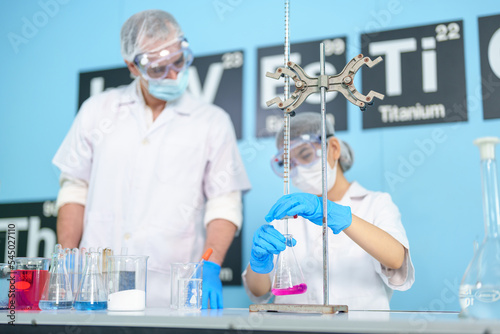 Modern medical research laboratories Beautiful female scientist wearing protective goggles mixes chemicals in test tubes in laboratory biochemical samples  an advanced science laboratory for medicine.
