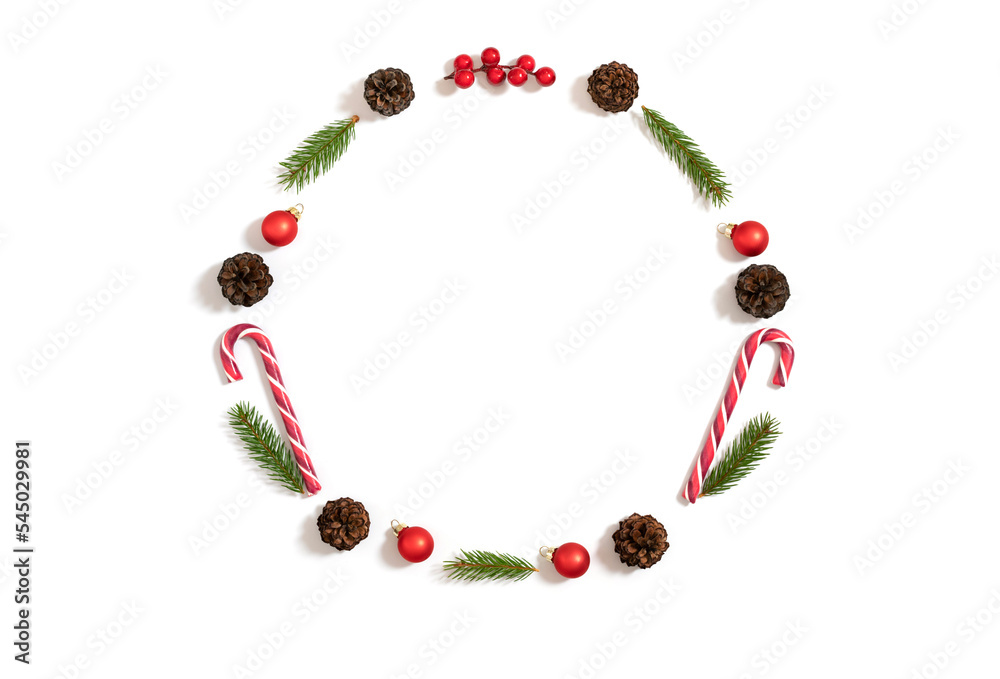 Christmas round frame with fir branches, cones, baubles and lollipops isolated on a white background. New Year wreath. Copy space, top view, flat lay. Christmas round frame with fir branches, cones, baubles and lollipops isolated on a white background. New Year wreath. Copy space, top view, flat lay.