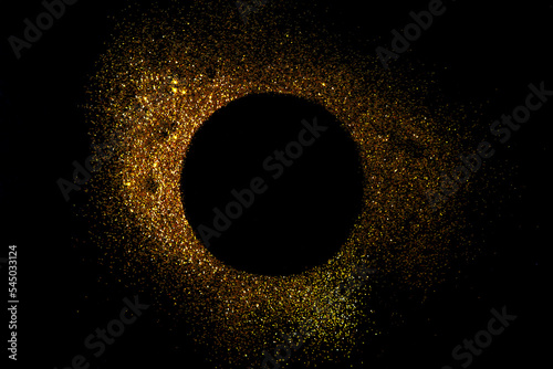 Dark texture with a round sprinkling of gold. Backdrop with golden sparkle for frame, copy space, and overlay photo effect. fancy, luxury, themed backgrounds.