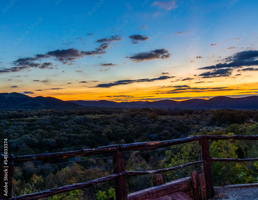 Sunrise Coming over Hills at aTexas Hill Country Overlook With a Fence