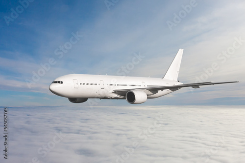 White wide body passenger jet plane fly in the air above the clouds