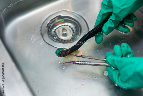 Cleaning dental instruments by hand in sink