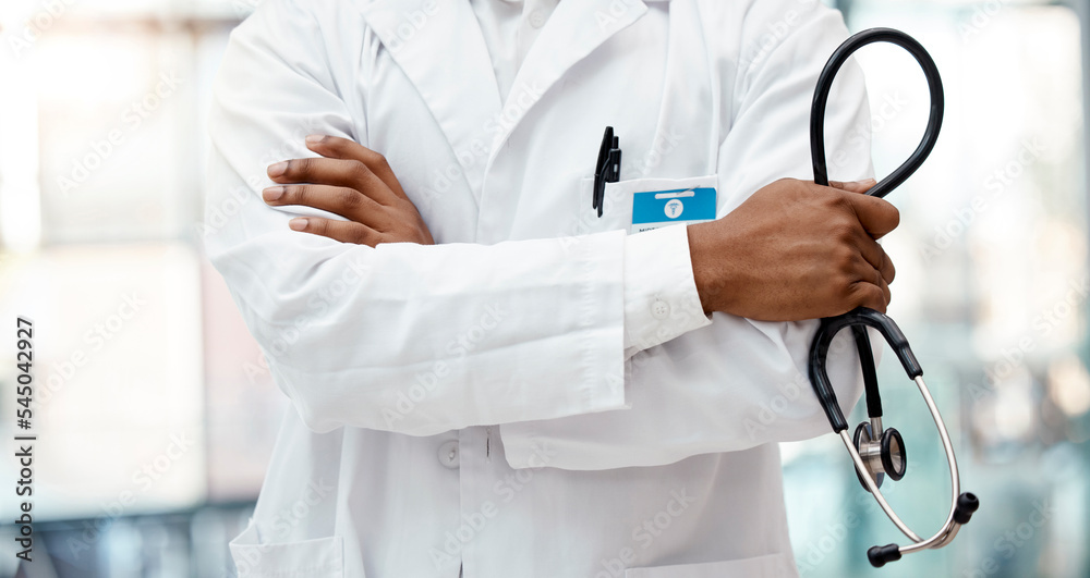 Healthcare, hospital and hands of doctor with stethoscope standing in clinic with arms crossed. Leadership, support and african american health care worker with medical equipment for innovation