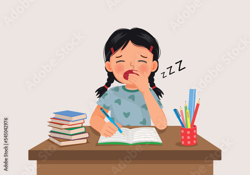 cute little girl yawning feeling sleepy while studying doing homework on the desk