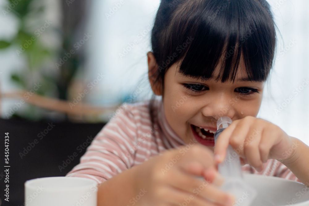 Little asian girl saline nasal wash nose at home. Little asian girl saline nasal wash nose at home.