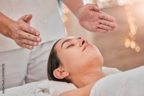 Spa, massage and reiki with head of woman for energy, chakra and spiritual therapy. Health, wellness and holistic healing with hands of therapist in salon for luxury, relax and alternative medicine