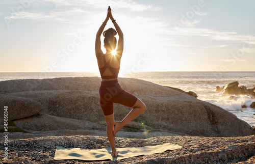 Photography Peace, yoga and sunset with woman at beach on rocks for fitness, zen and meditation wellness