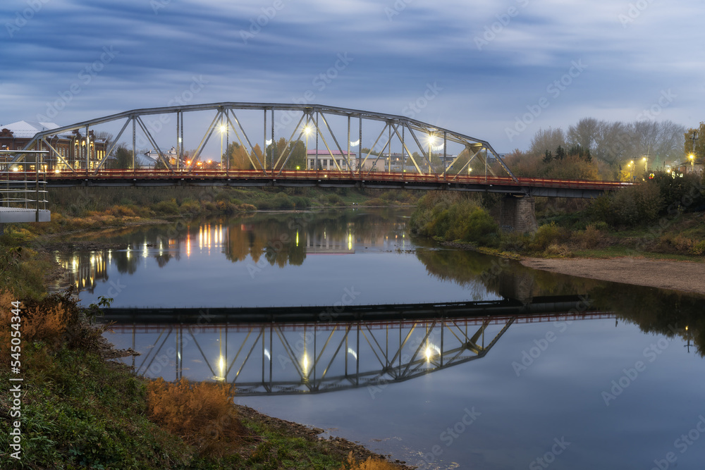 Automobile bridge across the river Sylva (Kungur, Russia) in the evening.