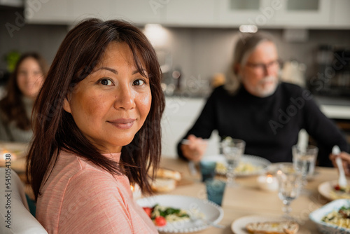 Portrait of woman having dinner with family